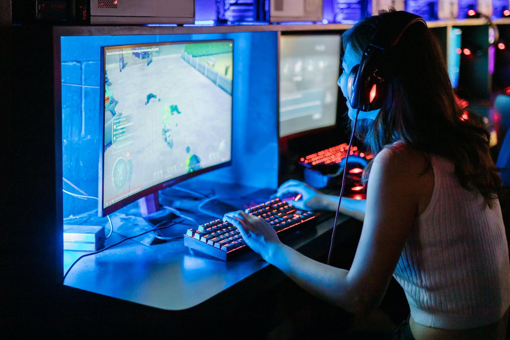 woman in front of screen showing video game