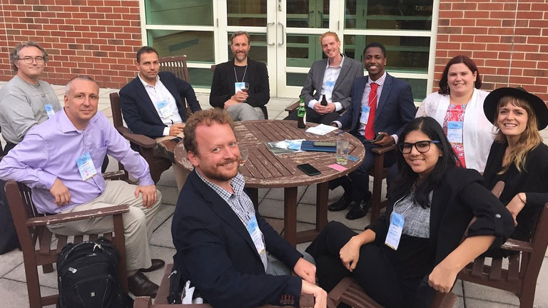 Members of the Project Drawdown research team seated around a table at a conference