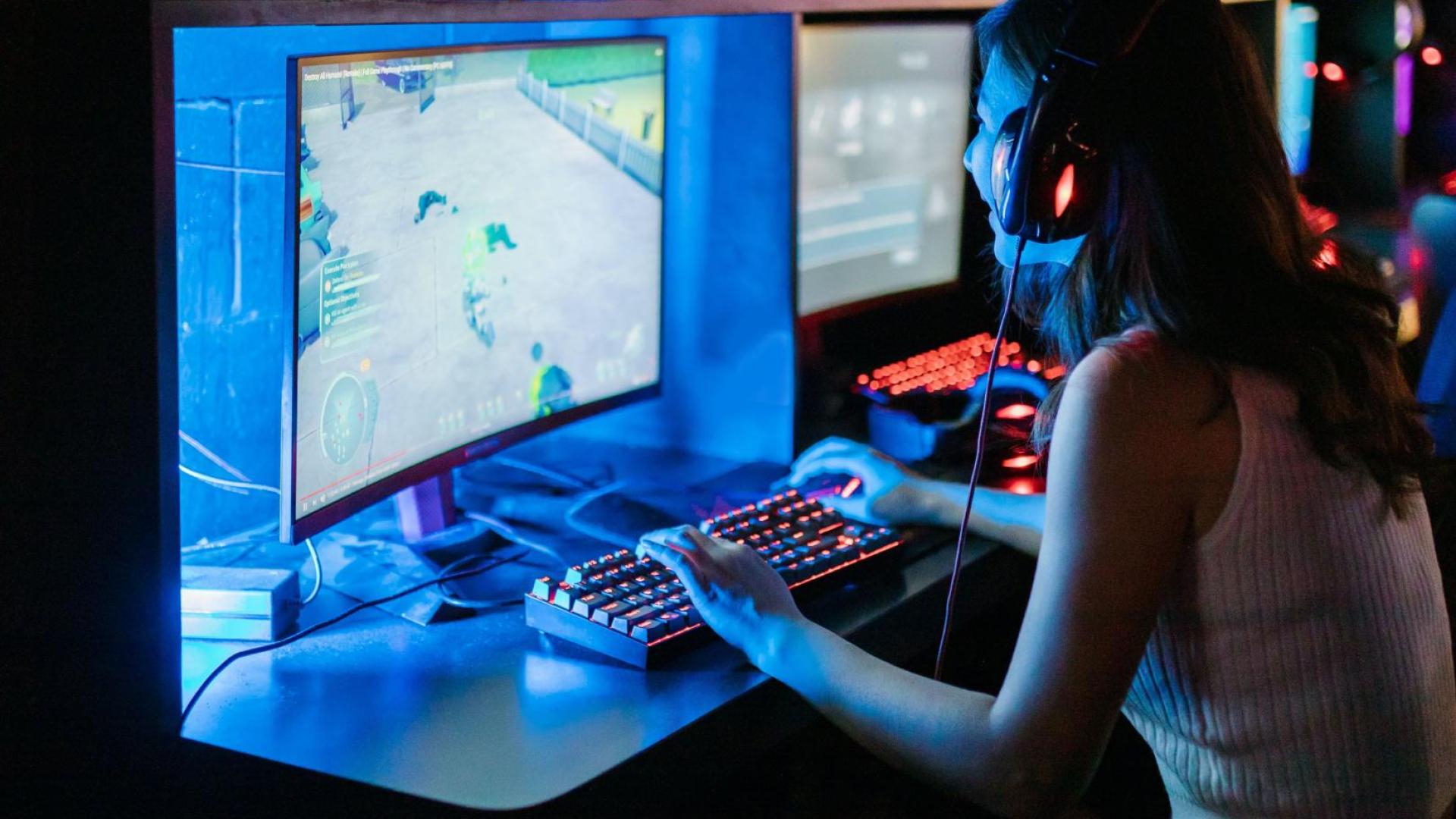 woman in front of screen showing video game